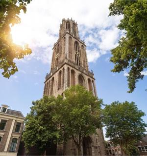 a tall building with the sun in the sky