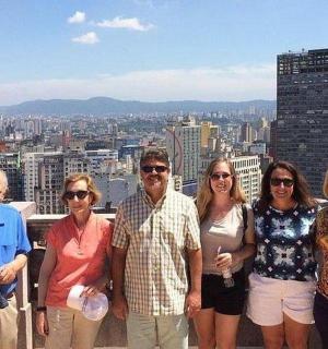 a group of people standing on top of a building