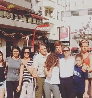 a group of people posing for a picture on a street