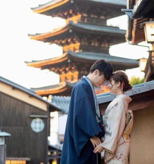 a man and a woman standing next to a building
