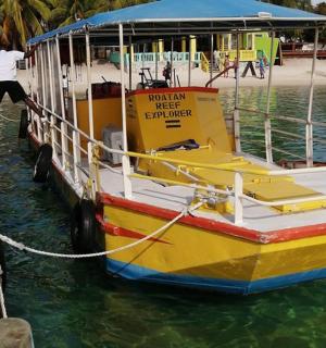 a yellow boat is tied to a dock
