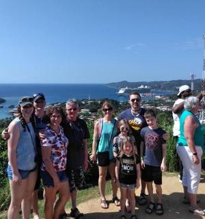 a group of people posing for a picture on a hill