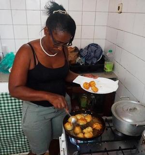 a woman in a kitchen preparing food in a pan