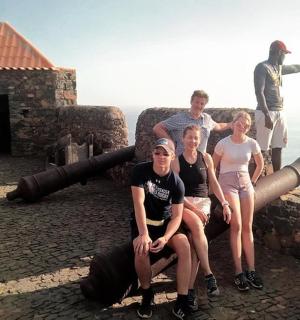 a group of people sitting on top of a cannon