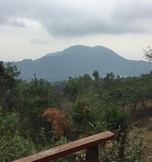 a bench on a hill with mountains in the background