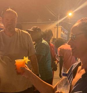 a woman holding a drink in a crowd of people