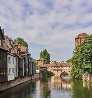 a river in a city with buildings and a bridge