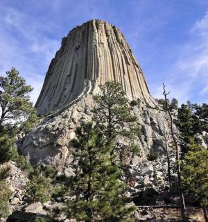 a large stone mountain with trees in the foreground