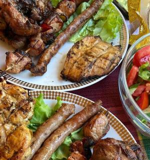 a table with three plates of food and a salad