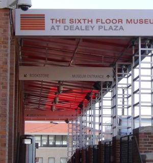 a sign for the sixth floor museum at deadly plaza