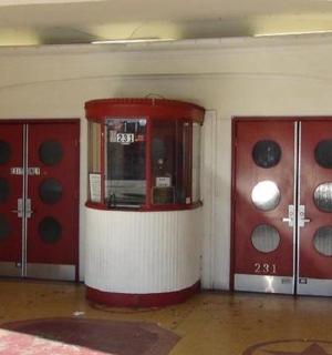 a room with two red doors and a machine