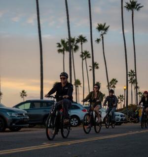 a group of people riding bikes down a street