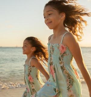 two young girls walking on the beach