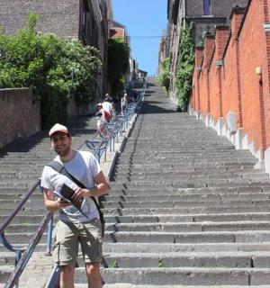 a man standing on some stairs with a camera