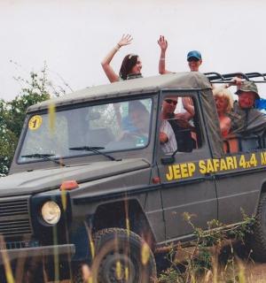 a group of people riding in the back of a truck