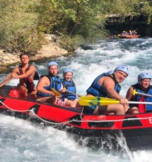 a group of people in a raft on a river