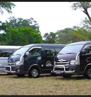 four vans parked in a row in a field
