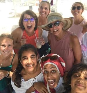 a group of women are posing for a picture