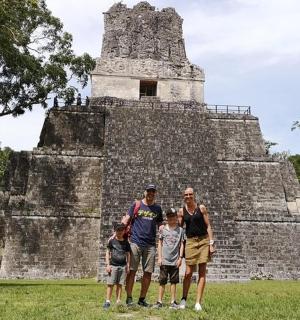 a group of people standing in front of a pyramid