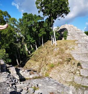 a man standing on the side of a pyramid