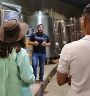 a man and a woman standing in a brewery