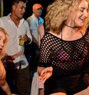 a woman standing next to a girl on a dance floor