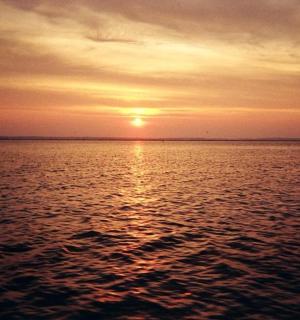 a sunset over a large body of water