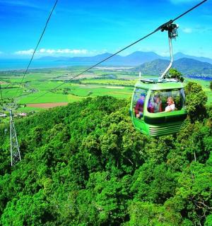 a group of people riding a gondola over a mountain
