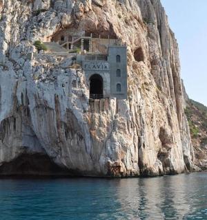 a building on the side of a rock cliff