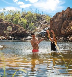 a man and a woman standing in a river