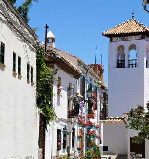 a street with white buildings and a clock tower