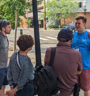 a group of people waiting at a bus stop