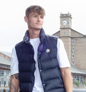 一名男子身穿带有钟楼图案的羽绒背心