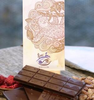 a box of chocolate and a bowl of berries