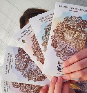 a woman holding three cards in her hands