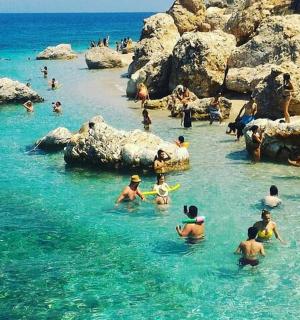 a group of people in the water at a beach