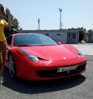 a woman is standing next to a red car