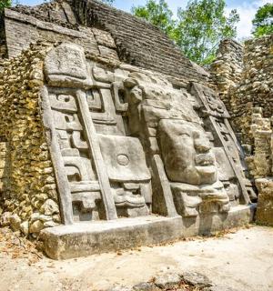 a stone wall with a statue on the side of a building