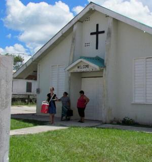 a group of people standing outside of a church