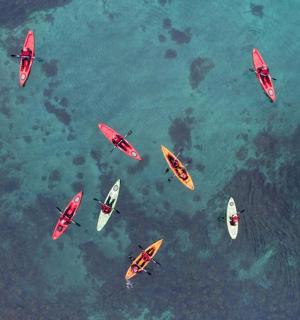 a group of people in kayaks in the water
