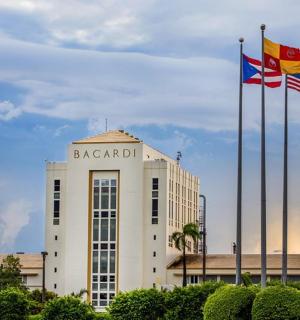 two flags are flying in front of a building