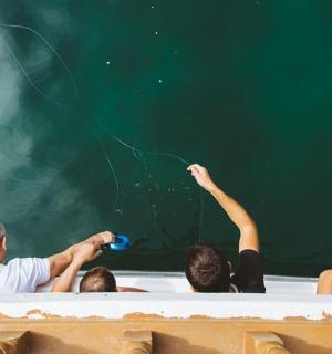 a group of people sitting in front of a blackboard