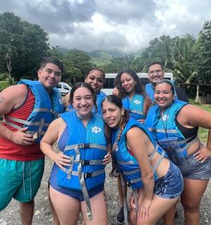 a group of people in life jackets posing for a picture