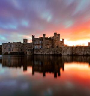 a castle sitting on top of a body of water