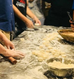 a group of people preparing food on a counter