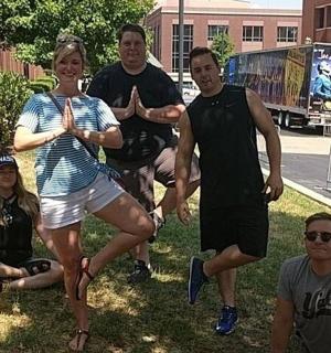 a group of people standing in the grass