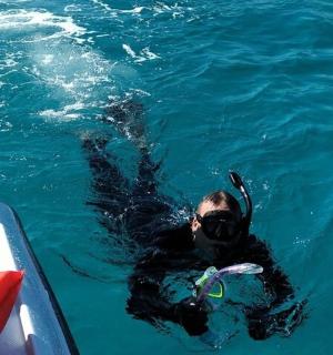 a person in the water next to a boat