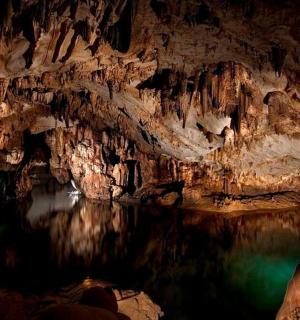 a cave with a pool of water in it
