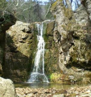 a waterfall on the side of a rock wall