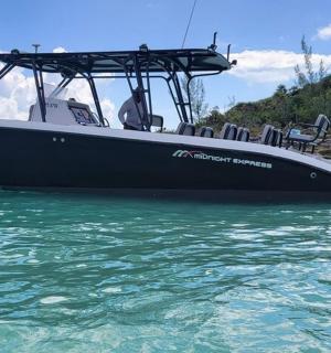 a boat sitting in the water in the ocean